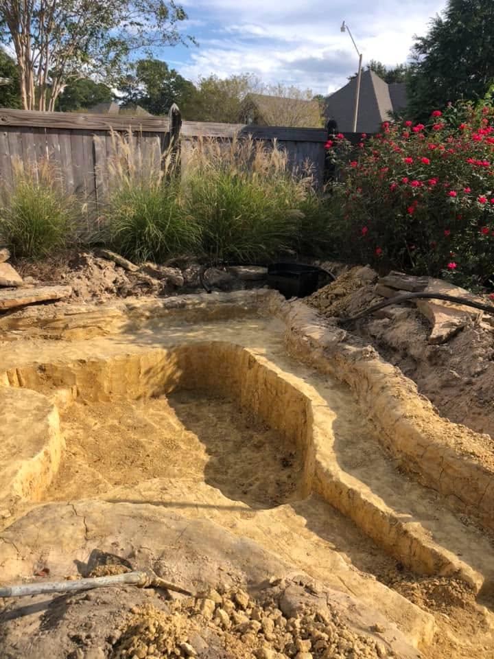 Decorative stone waterfall repair in Madison, MS with LED lighting and restored water feature performance