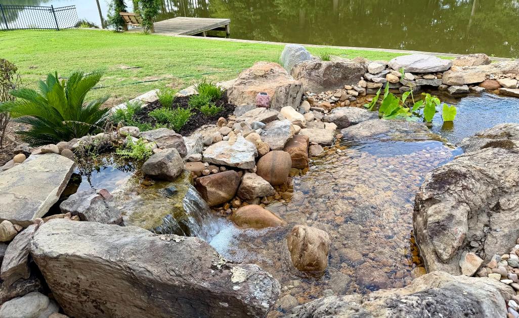 Complete waterfall cleaning in Madison, MS with decorative plants, flowers, and a professionally maintained water feature