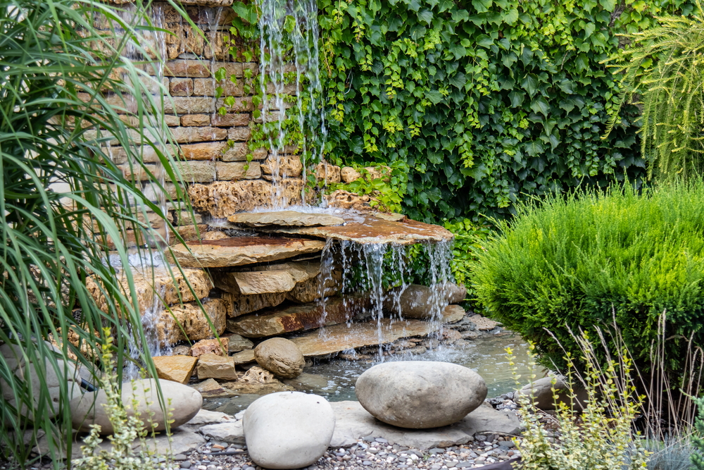 A,small,decorative,waterfall,in,the,garden.,landscape,design